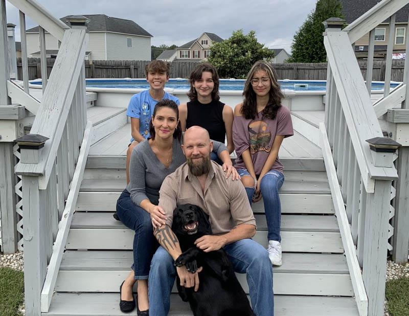 The Pharris family, clockwise from top left: Isabelle, Madison, Tristan, Jennifer and Jeff – who is holding his loyal black labrador, Murphy. (Photo courtesy of Jeff Pharris)